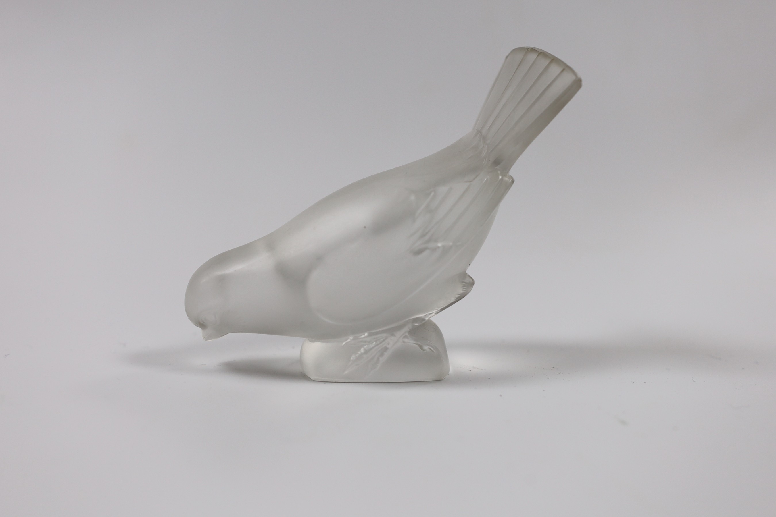 Two Lalique glass paperweights modelled as pecking birds, together with another Lalique swan modelled pin dish